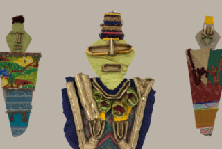 Three abstract, colourful figures made from fabric and textured materials stand against a neutral background. Each figure displays unique patterns, evoking creativity.