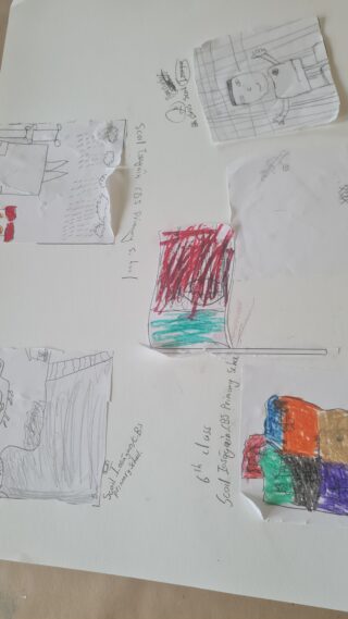 Five children's drawings on paper, each featuring colourful scribbles and sketches. The scattered artwork conveys a playful and creative atmosphere.