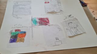 A collection of hand-drawn sketches on paper, featuring colourful patterns and doodles, scattered across a wooden surface, conveying creativity and spontaneity.