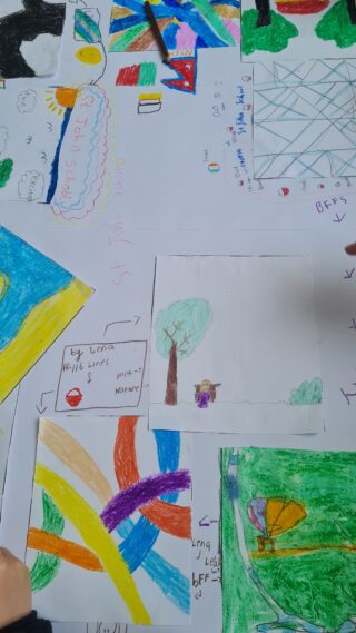 Colourful children's drawings scattered on a surface, featuring abstract shapes, trees, and a rainbow. The mood is playful and creative.