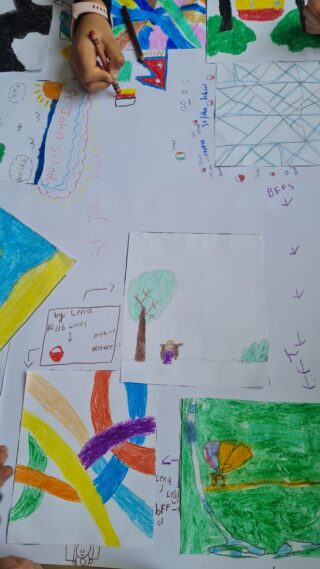 Children's colourful drawings cover a paper with a hand placing crayons. Includes rainbows, trees, and abstract shapes, conveying creativity and joy.