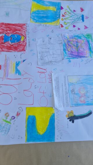 Colourful children's drawings cover a sheet of paper, featuring abstract shapes, scribbles, and vibrant colours, conveying a playful and creative tone.