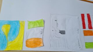 Child's drawing on paper featuring colourful abstract shapes. Blue and yellow form a wave on the left, with scattered green, orange, and red shapes on the right.