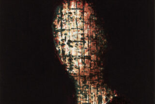 Abstract painting of a face in warm hues, partially obscured by a grid pattern. The dark background creates a mysterious, haunting atmosphere.