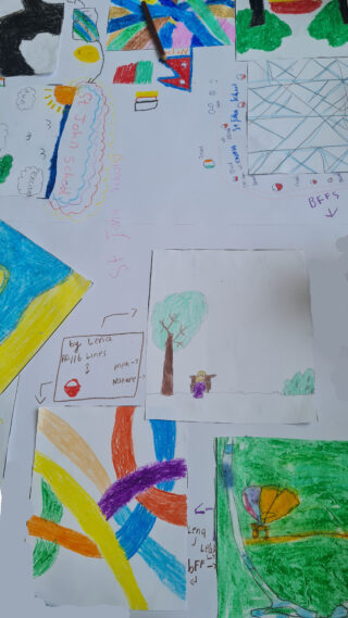 A collection of colourful children's drawings on white paper, featuring abstract shapes, a tree, and vibrant patterns, conveying creativity and joy.