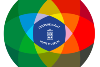 A colourful circular design features overlapping segments in red, orange, green, blue, and yellow. The centre has a blue circle with text: 