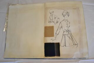 Fashion design sketchbook page featuring two illustrated outfits and three fabric swatches in beige and dark tones.