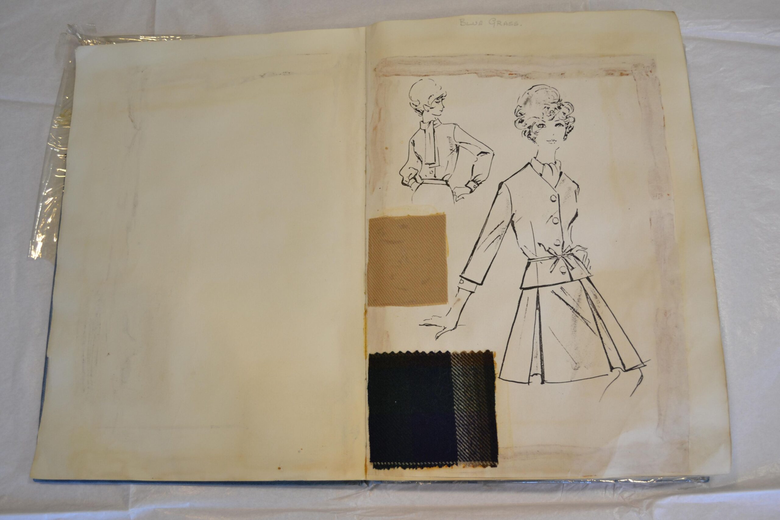 Fashion design sketchbook page featuring two illustrated outfits and three fabric swatches in beige and dark tones.